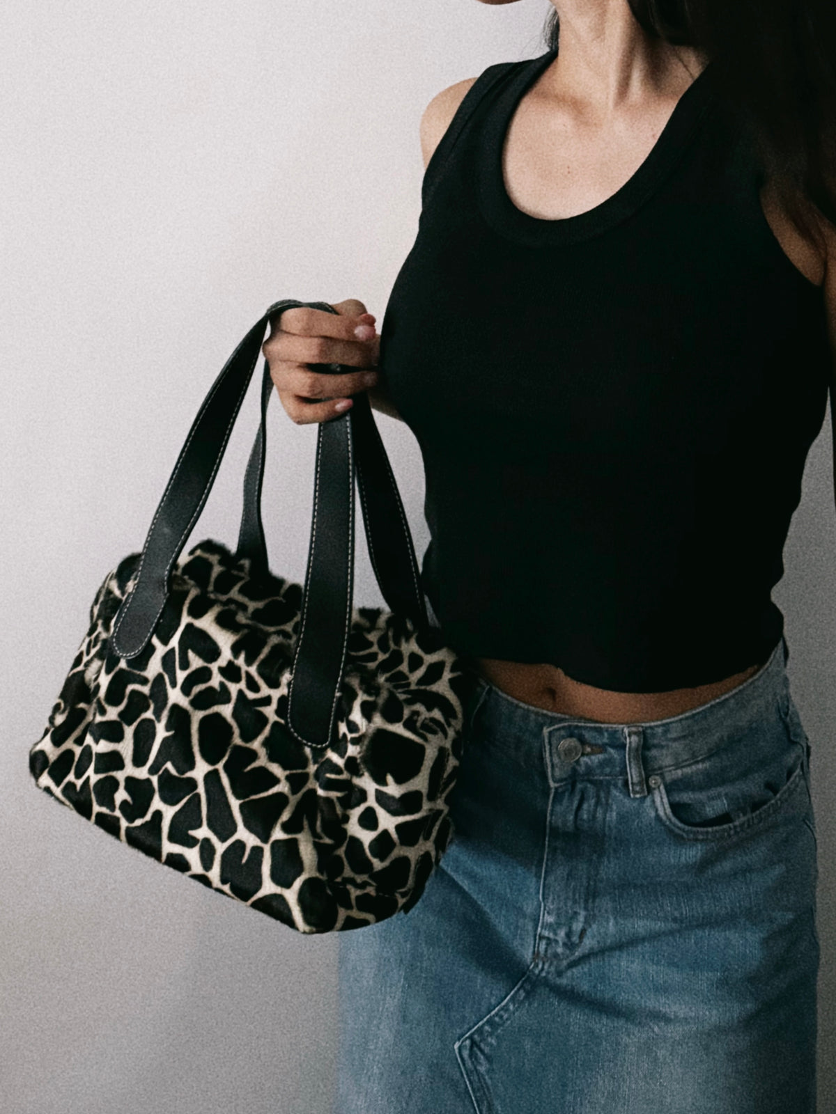 03. Guia’s giraffe print pony hair bowling bag