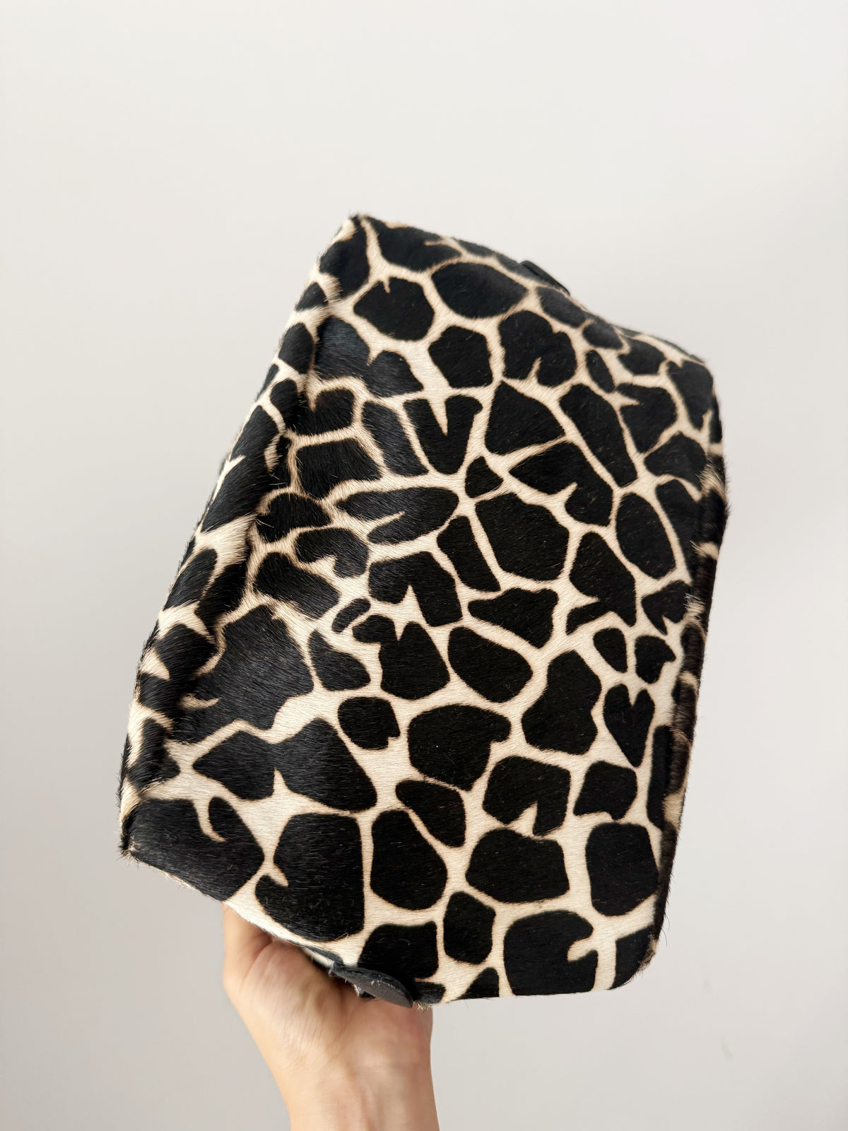 03. Guia’s giraffe print pony hair bowling bag
