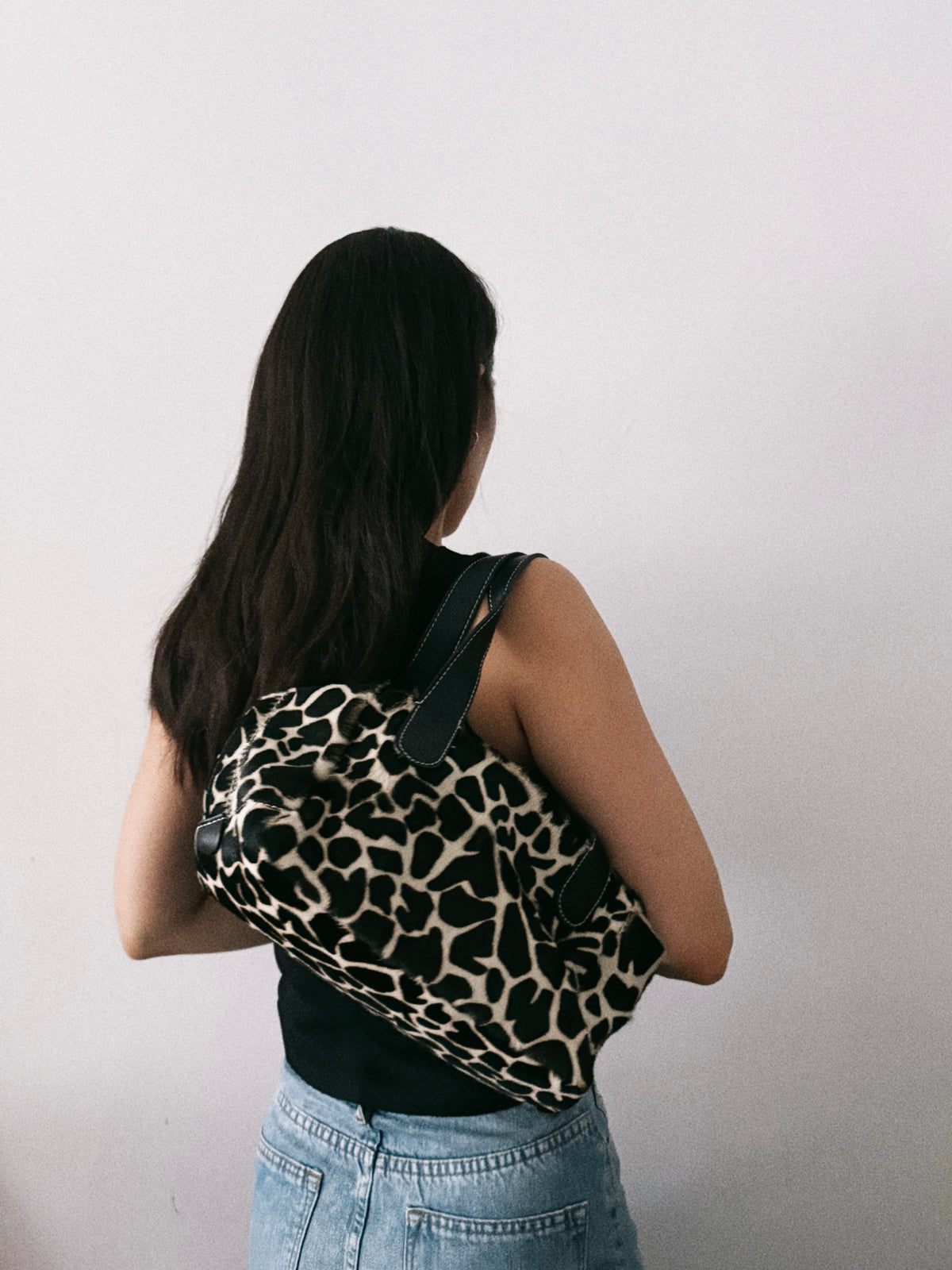 03. Guia’s giraffe print pony hair bowling bag