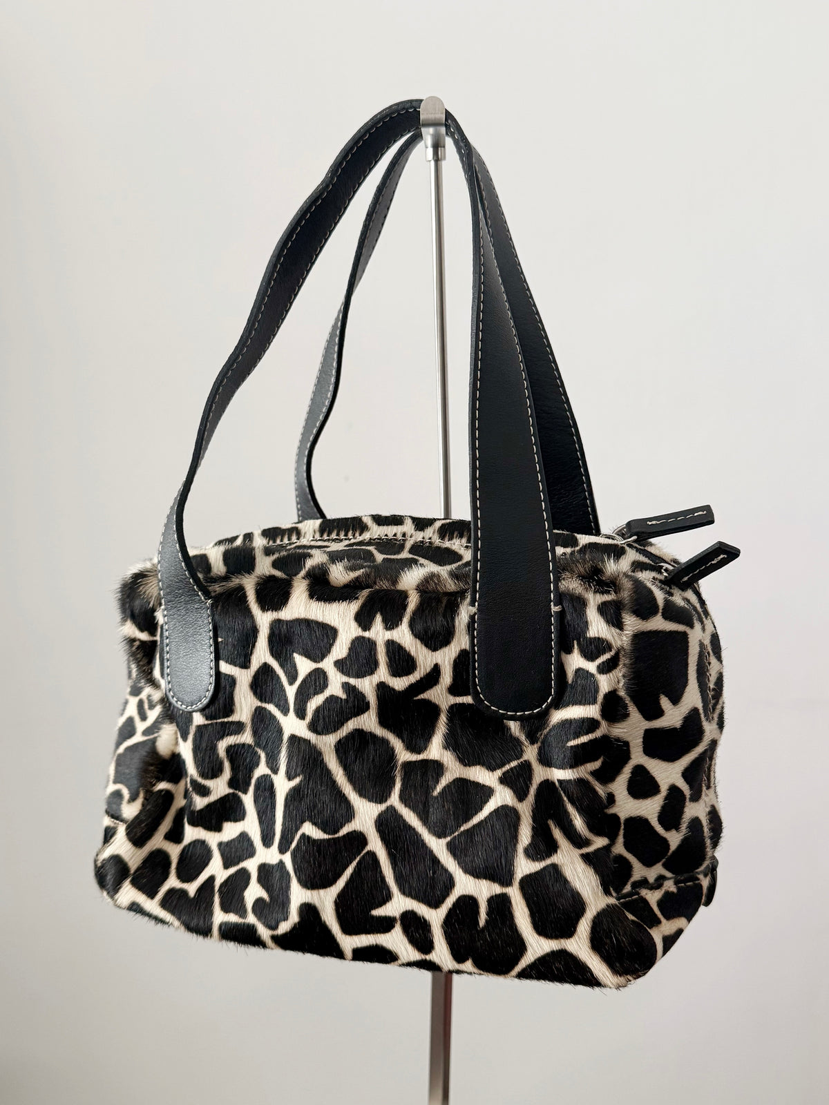03. Guia’s giraffe print pony hair bowling bag