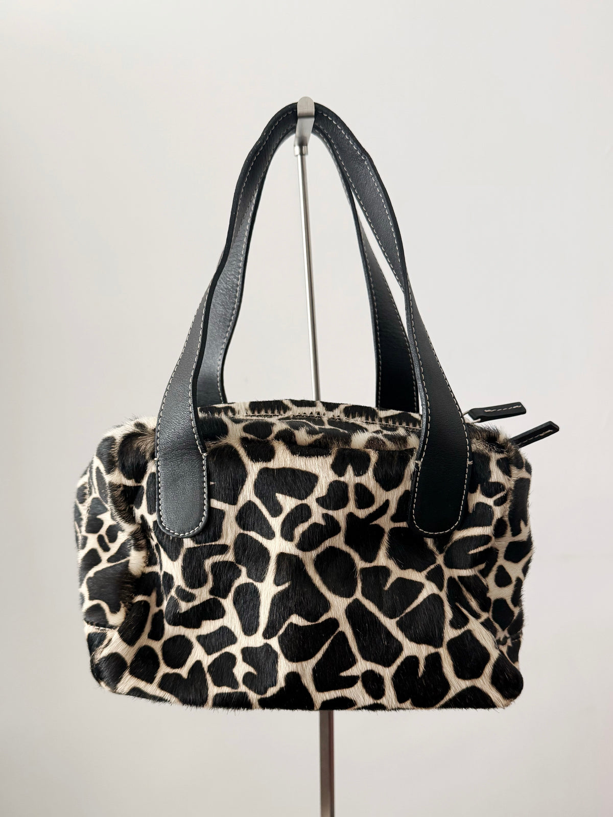 03. Guia’s giraffe print pony hair bowling bag