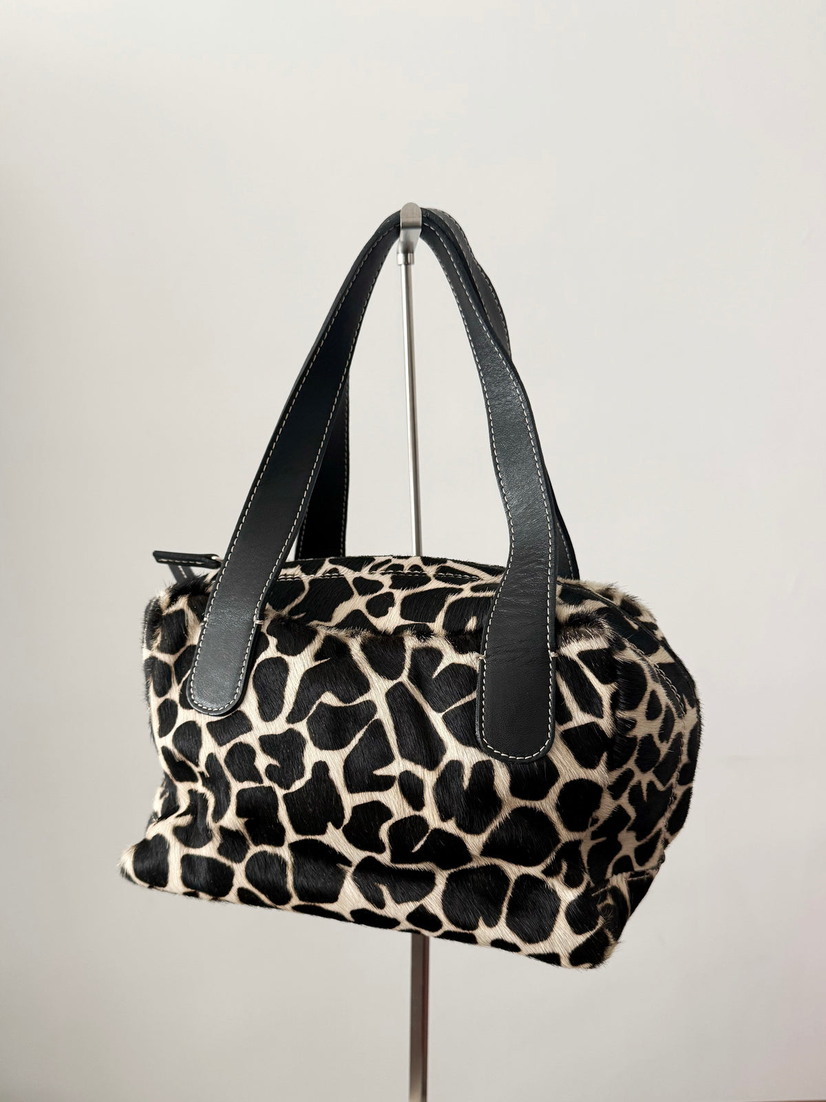 03. Guia’s giraffe print pony hair bowling bag