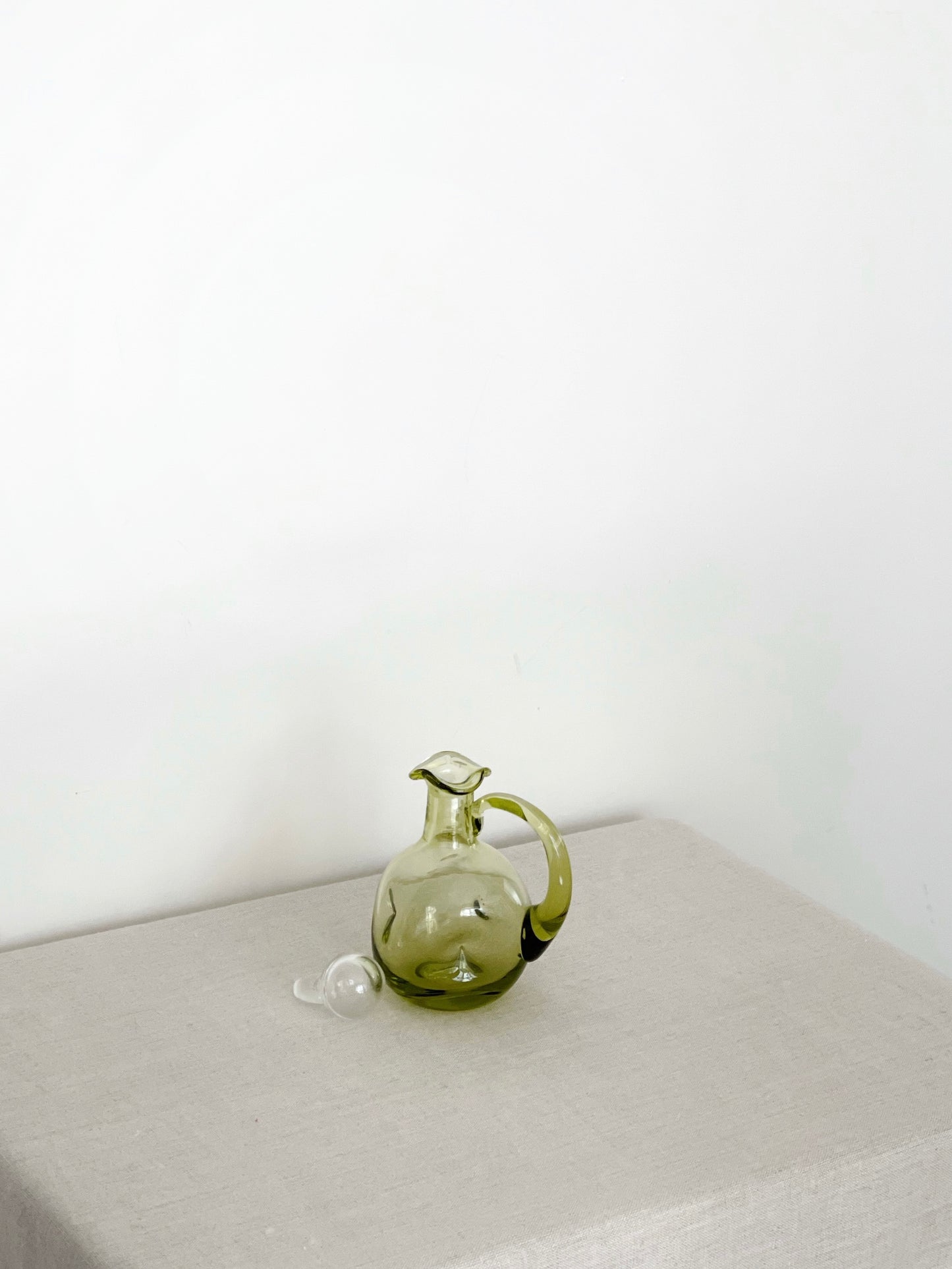 Handblown green pinched glass cruet with clear glass stopper